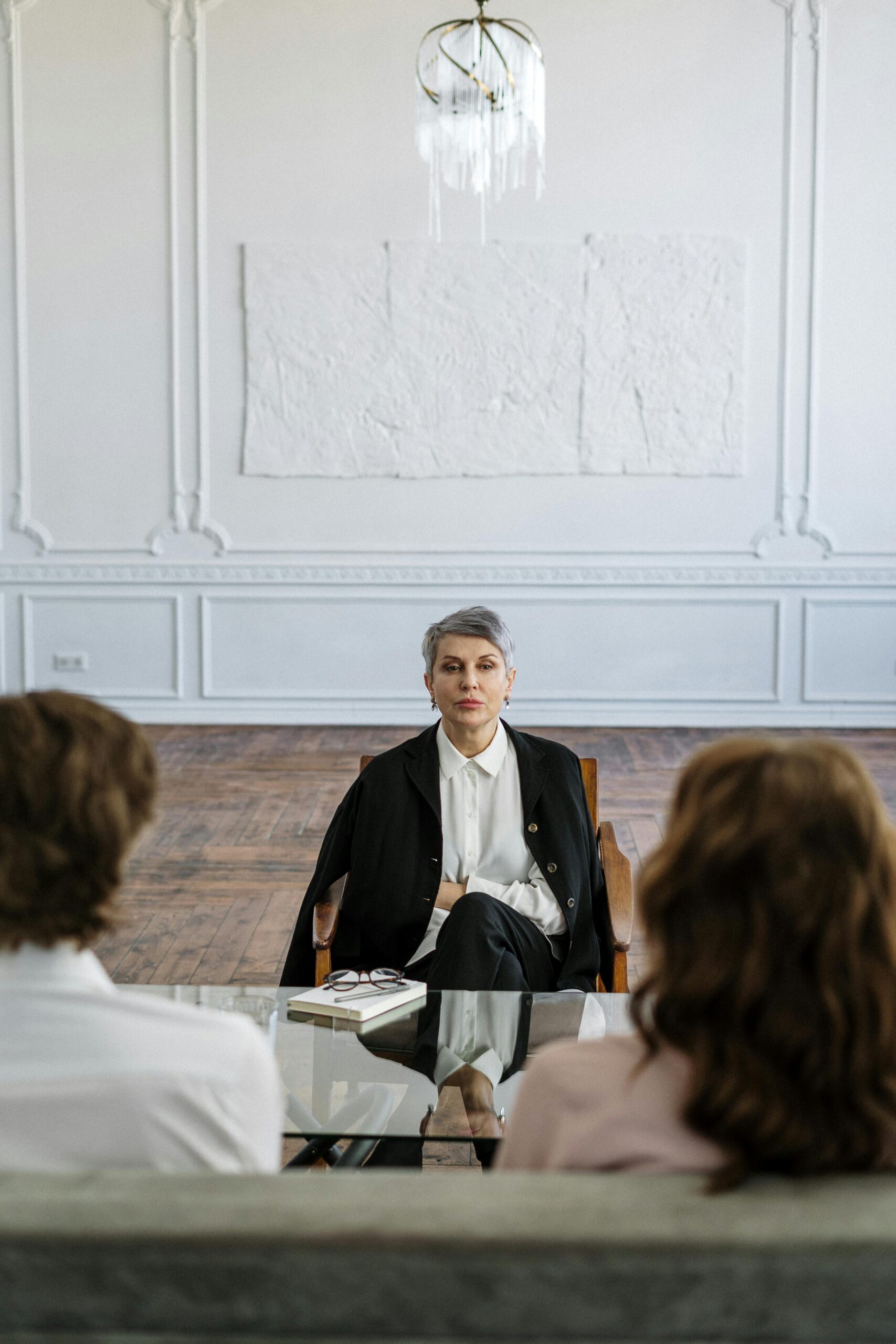 Couple receiving guidance from therapist in a stylish and serene office setting.